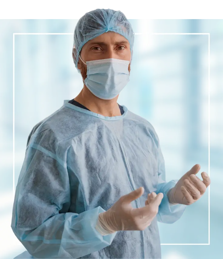 A healthcare professional in a surgical suit and mask, ready to perform a medical operation.